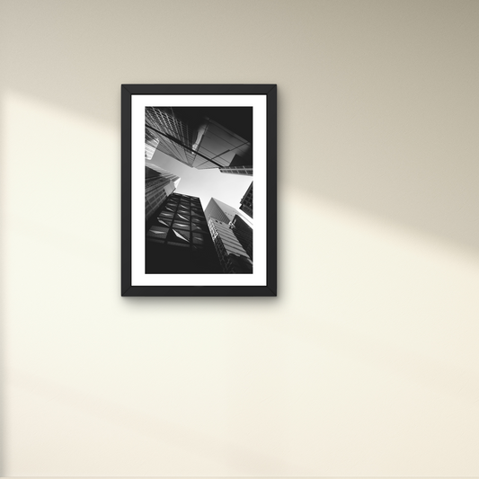 Framed modern wall art featuring a cityscape tapestry in black and white.



