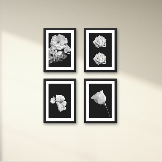 Set of four minimalist floral wall art pieces in black and white, ideal for home decor.



