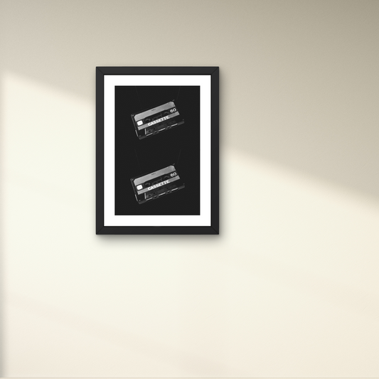 Retro wall art featuring two classic cassette tapes in black and white for nostalgic decor.



