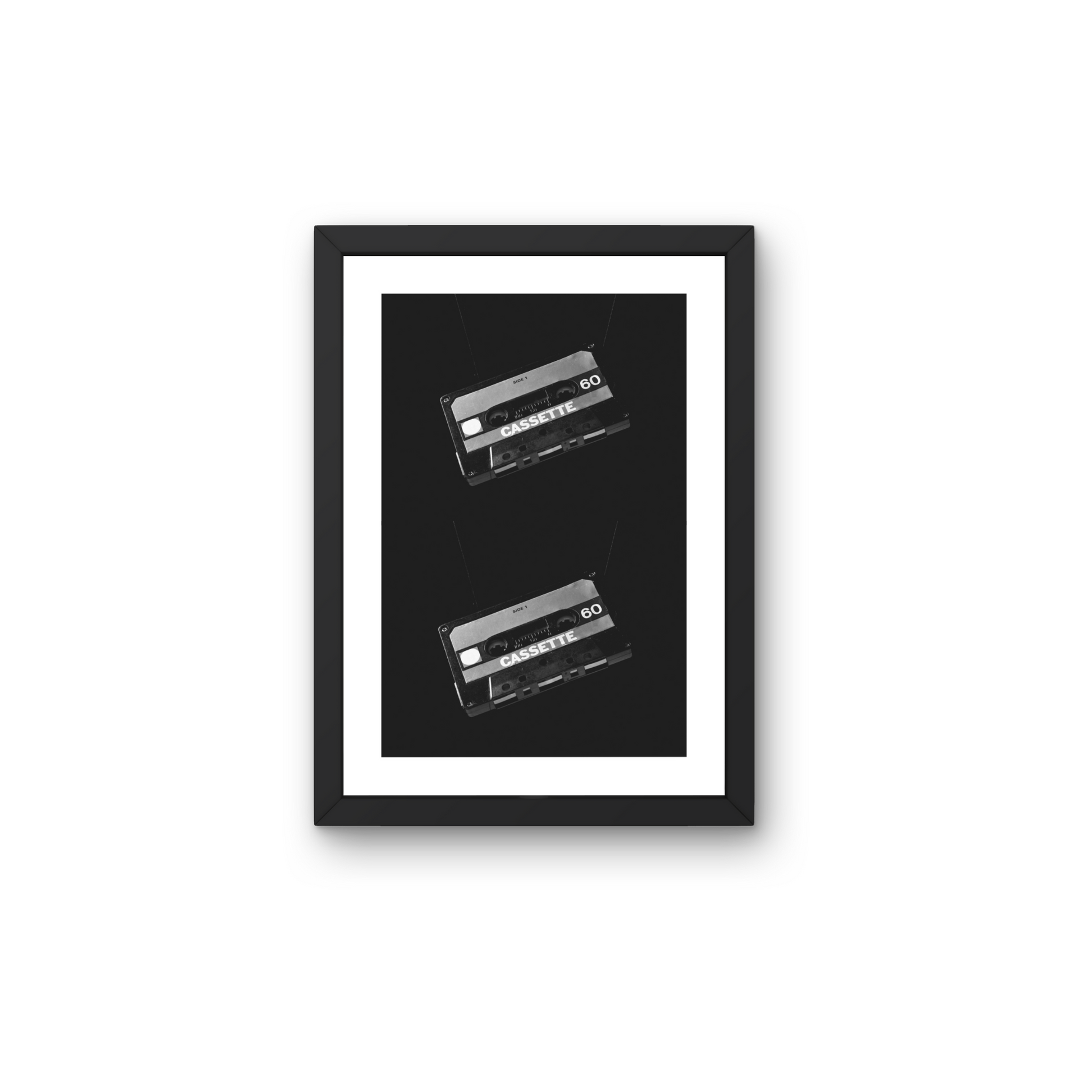 Retro wall art featuring two classic cassette tapes in black and white for nostalgic decor.



